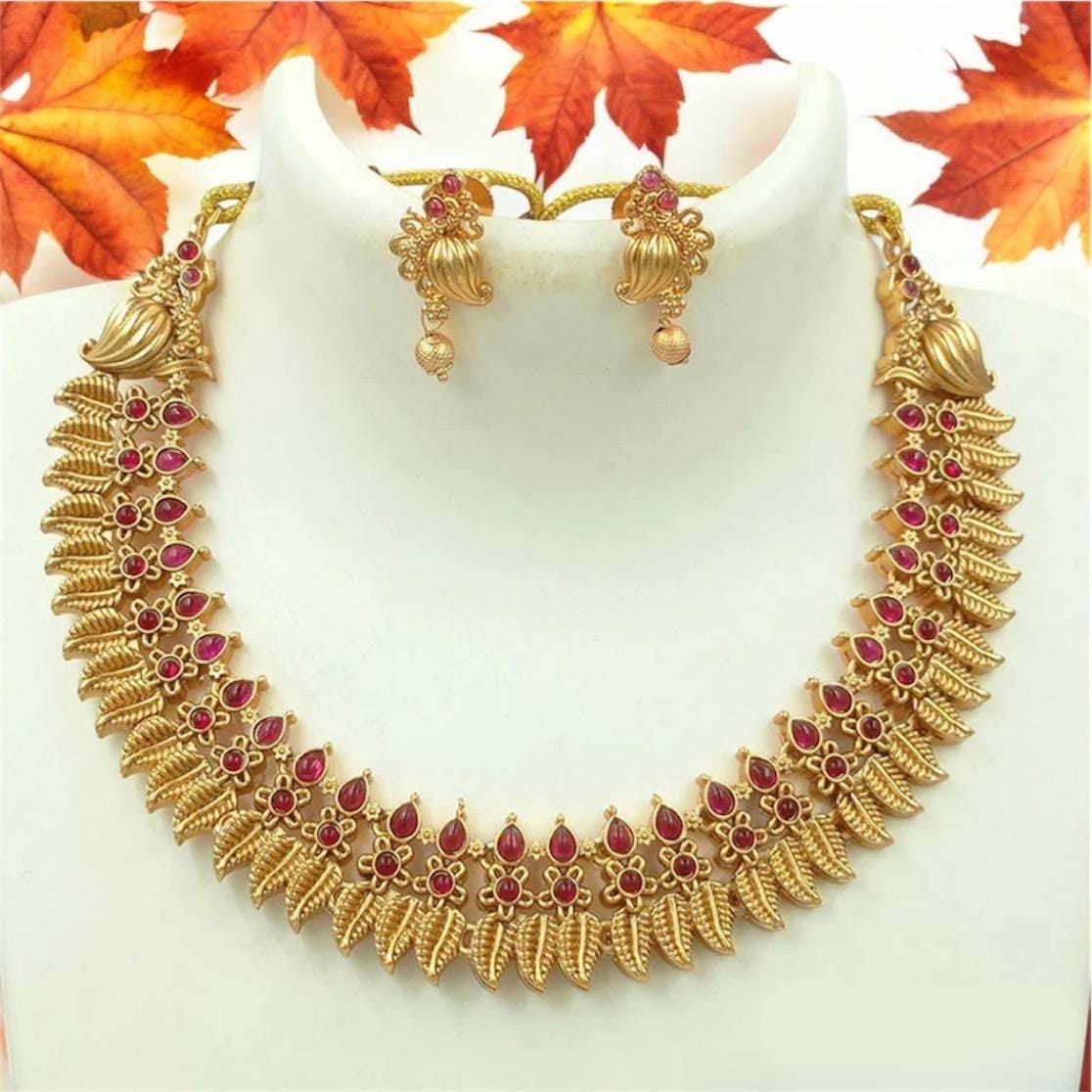 Gold toned choker necklace set with red stone