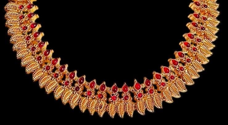 Gold toned choker necklace set with red stone